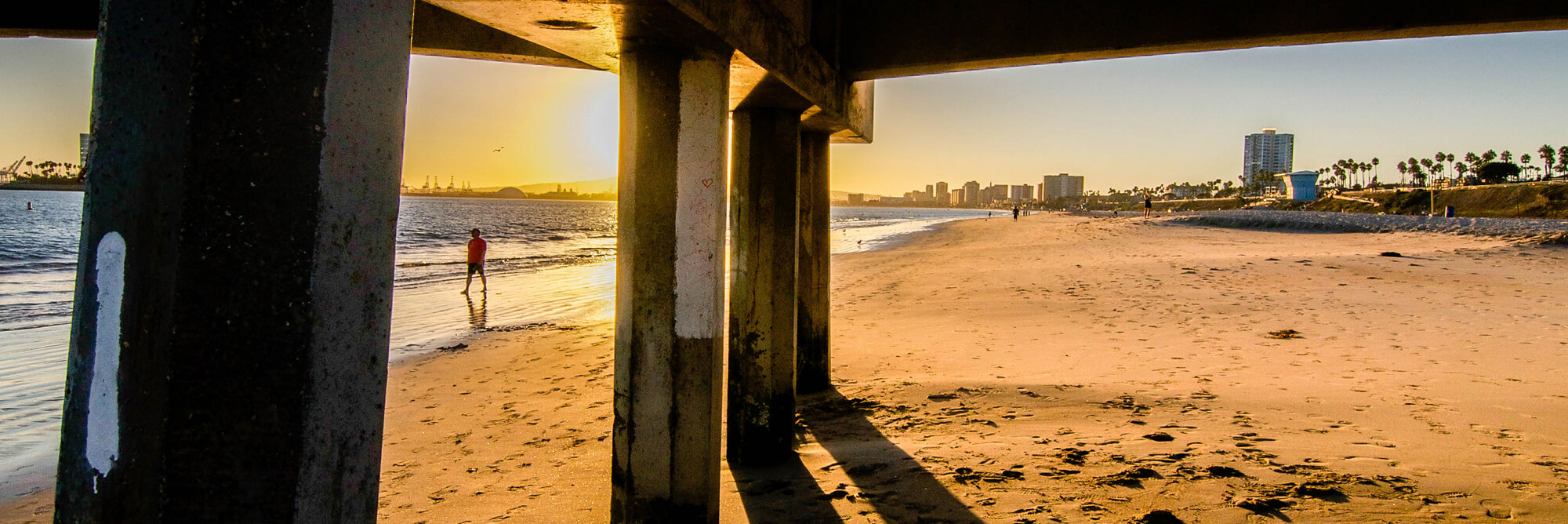 A background scene of a beach and sun setting