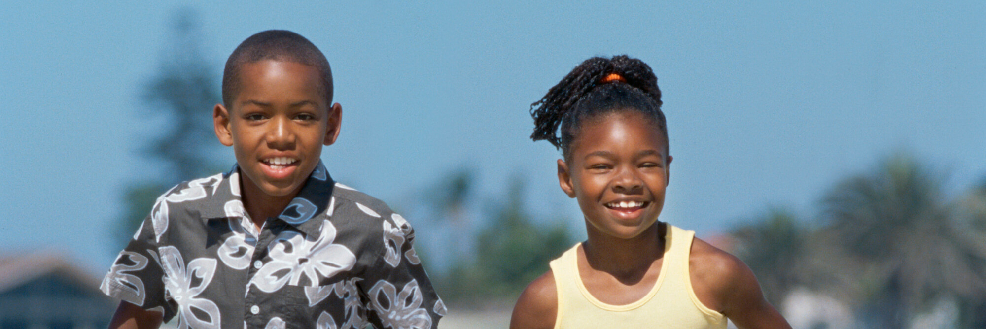 Two children running and smiling