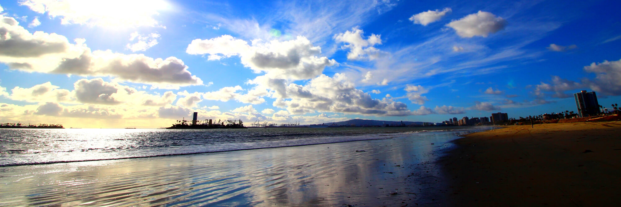 The beach, ocean, and a few buildings in the distance