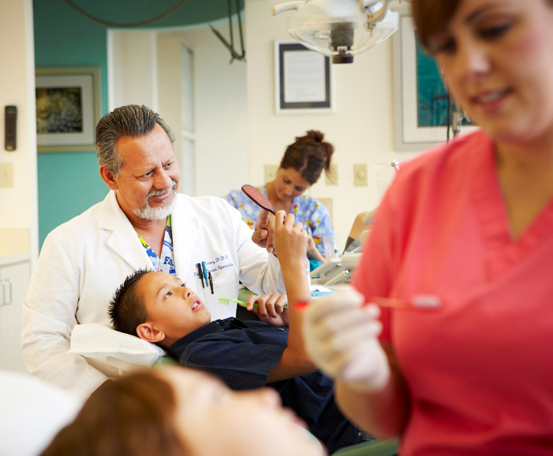 A photo of inside the office, Dr. Cortez treating a patient