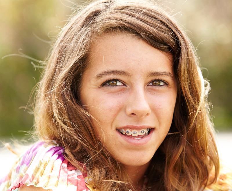 A girl with braces smiling