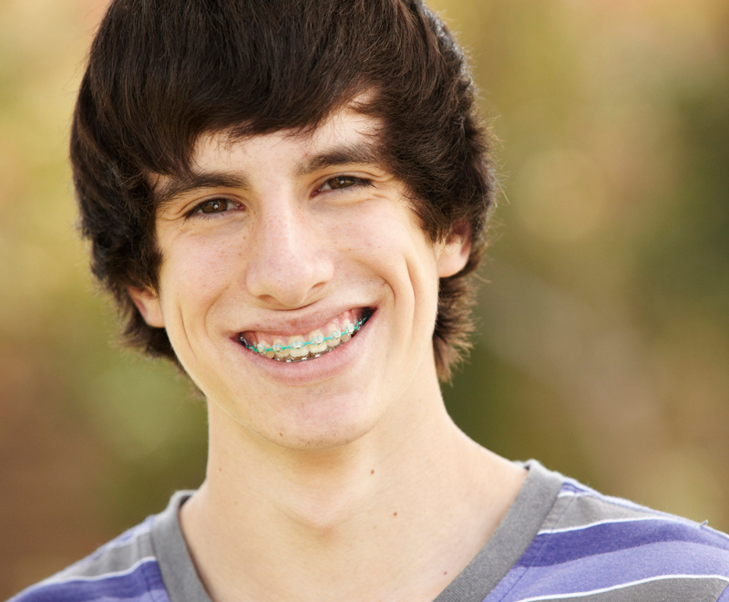 Teenage boy with braces smiling