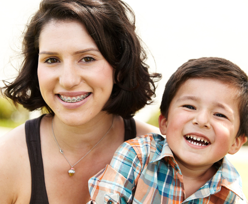 A mother with braces holding her son