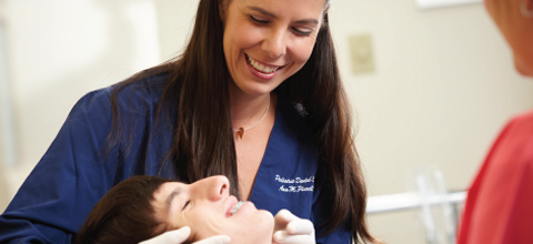 Doctor inpecting patient as they both enjoy a smile