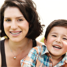 A mother and son, laughing. The mother has braces